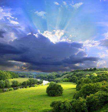 This marvelous scene of grassy fields, a river, groves of trees, approaching dark clouds, with rays of light coming from behind them illustrates Index M of subjects by Peace Publishers.