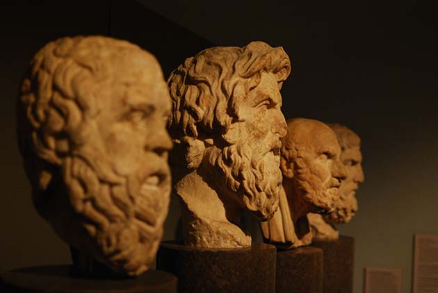 Fotografía compuesta de cuatro bustos de filósofos griegos antiguos.