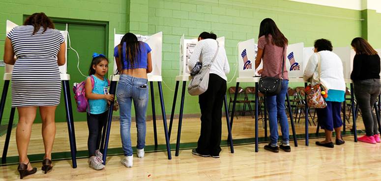 Fotografía de ciudadanos latinos de los Estados Unidos de América en el acto de votar, para el ensayo sobre el Voto cristiano. 