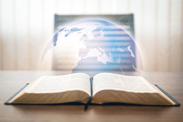 An image showing an open Bible before the globe of earth to illustrate the the Great Commission of Jesus to take the gospel to all the world.