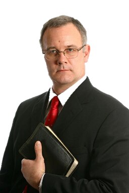 Foto que representa a un predicador de púlpito en una iglesia de Cristo.