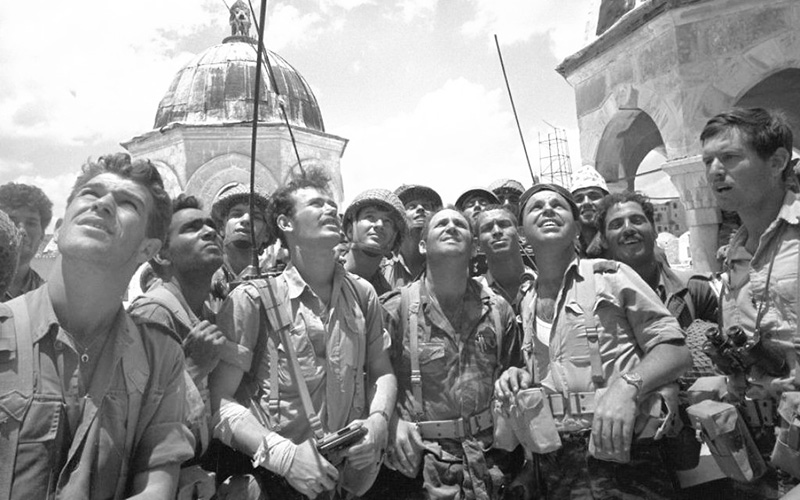 Israeli paratroopers looking up at part of the Old City of Jerusalem which was taken by Israeli forces, June 7, 1967.