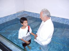 Omar baptized by his grandfather in the church of Christ, Bayamon, Puerto Rico.