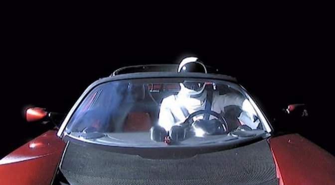 Starman the astronaut at the wheel of the Tesla Roadster, within the cargo chamber of the Falcon Heavy.