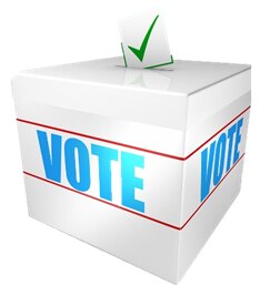 Una fotografía de una caja blanca  con la palabra VOTE en azul claro en la que echar papeletas para votar.